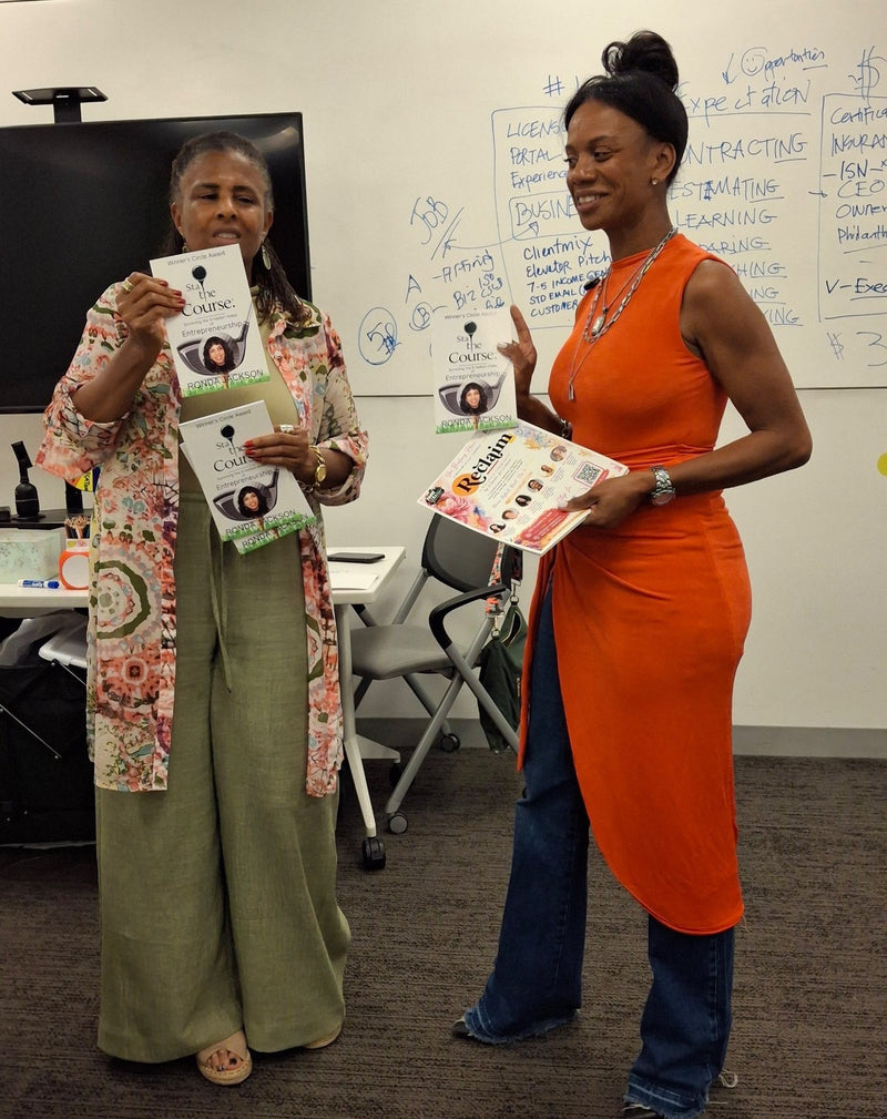Ronda Jackson with a participant holding copies of Stay the Course after a workshop