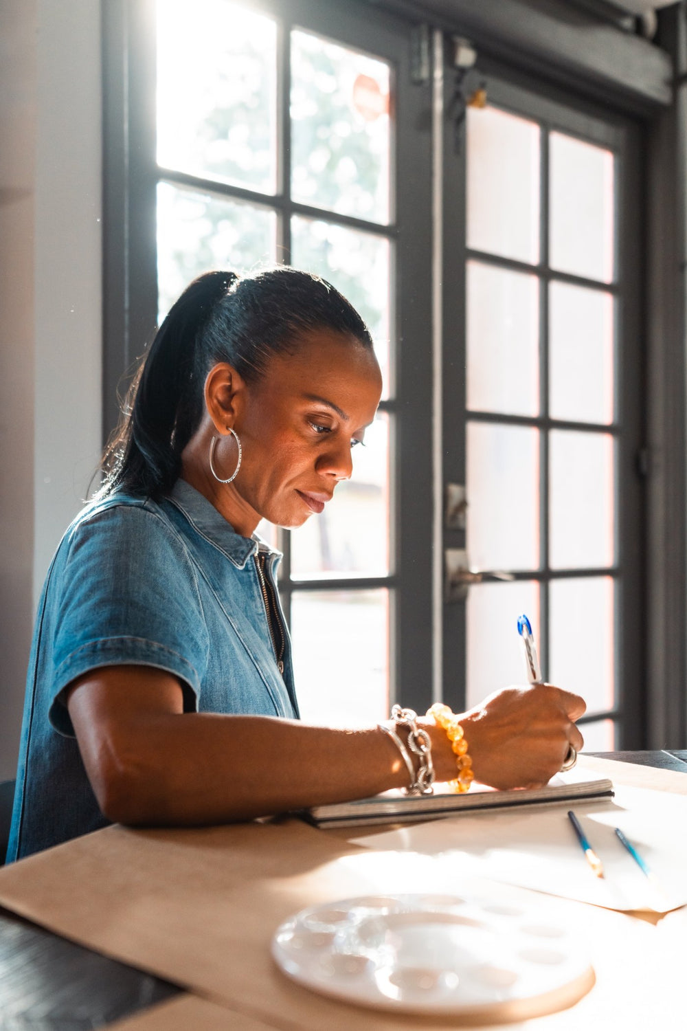 Ronda Jackson, author of Stay the Course, writing at her desk