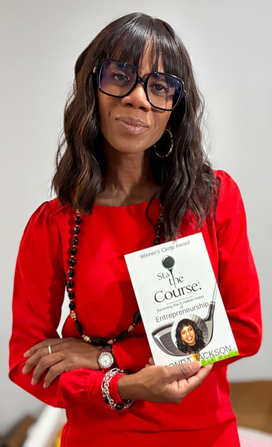 Ronda Jackson holding Stay the Course: Surviving the 9 Hellish Holes of Entrepreneurship, Winner's Circle Award